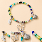 Pulsera Elástica | charms : pluma, mariposa y pez
